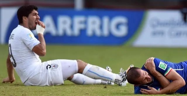 photo suarez se tient la mâchoire après avoir mordu chiellini (à droite) à l'épaule.  &copy; ouest-france