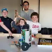 photo tony torché accompagné de l’équipe de champions : nathanaël, raphaël et tom, vainqueurs de la coupe de france robotique junior des pays de la loire.