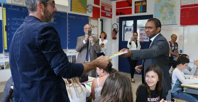 photo  pap ndiaye, ministre de l’éducation nationale, remet un recueil de fables de la fontaine au directeur de l’école de sainte-gauburge-sainte-colombe, dans l’orne, où il était lundi 20 juin 2022.  &copy;  ouest-france 