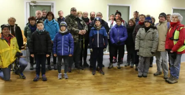 photo  au départ d’une marche nocturne téléthon, bertrand linquette (genoux à terre), entouré de bénévoles et marcheurs.  &copy;  ouest-france 