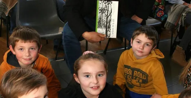 photo  jean-pierre siméon, lauréat du prix joël sadeler présente son ouvrage entouré des enfants.  &copy;  le maine libre 