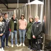 photo dans l’espace fabrication entre les cuves de fermentation de la brasserie mage malte (située à mamers, dans la sarthe), pauline, rémi, lucas et émilie, accompagnés de frédérique boyer et de franck royer.