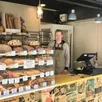 photo  sylvaine goulay au comptoir de sa boulangerie éphémère, à la décoration vintage. 