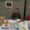 photo denis renard, présente ses ouvrages, lors du salon du livre des écrivains en suisse normande. « après la carneille, je vais travailler à la réalisation d’une bd autour du château et village de blangy-le-château en pays d’auge. »