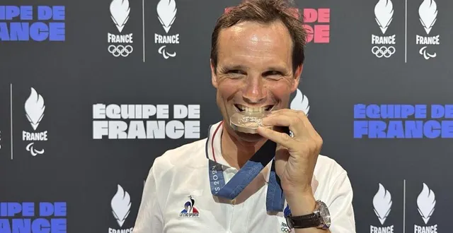 photo  nicolas touzaint croque à pleines dents sa médaille d’argent olympique qui complète sa collection après l’or de 2004 et le bronze de 2021.  &copy;  co 