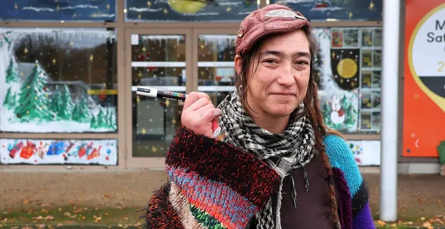 photo  nahéma lebatteux pose avec l’un de ses crayons devant la vitrine du magasin envia cuisines, qu’elle a peinte pour noël, route du mans, à sablé-sur-sarthe.  &copy;  ouest-france 