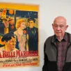 photo jean-pierre bleys devant une des affiches qui illustrera l’exposition à la grange-dîmière, à beaucouzé, à partir de mercredi.