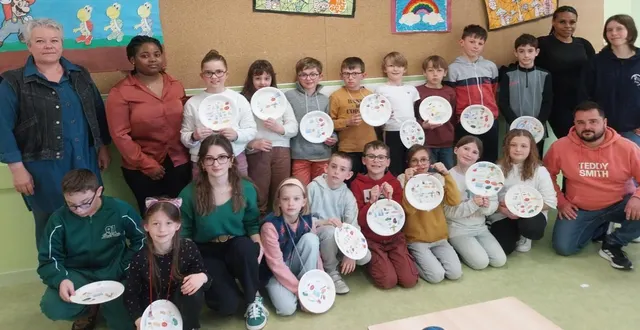photo  les écoliers, en compagnie des cinq élèves infirmiers, présentent l’assiette, qu’ils ont illustrée pour manger équilibré. à gauche, armelle journet, directrice de l’école.  &copy;  ouest-france 